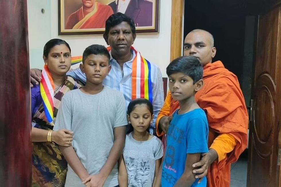 Sai Deena and his family with a Buddhist monk.